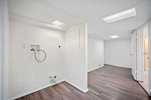 Washroom featuring wood finished floors, washer hookup, and electric dryer hookup