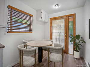 Dining space featuring plenty of natural light and dark wood finished floors