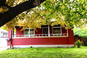 View of side of property with a sunroom and brick siding