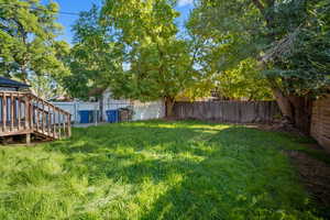 Fenced backyard with a gate and a deck