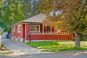 View of front of house with brick siding, a shingled roof, and a garage