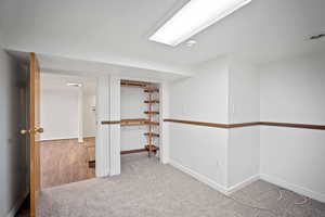 Carpeted empty room with baseboards