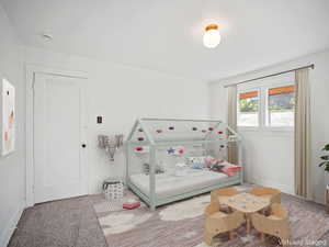 Bedroom featuring carpet flooring and baseboards