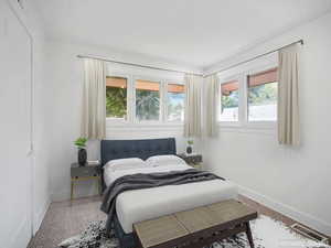 Carpeted bedroom featuring baseboards