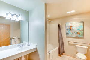 Full bath with tile patterned floors, shower / tub combo, and recessed lighting