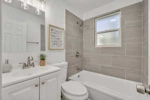 Full bath featuring shower / bathtub combination and vanity