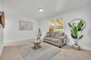 Living area with carpet and baseboards