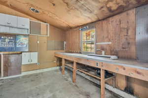 Misc room featuring vaulted ceiling and a workshop area