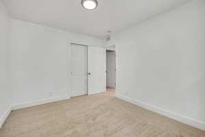 Unfurnished bedroom featuring carpet floors and a closet