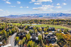 Aerial perspective of suburban area featuring a water and mountain view and a local golf course