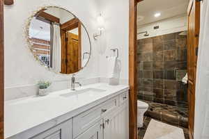 Bathroom featuring vanity and a shower stall