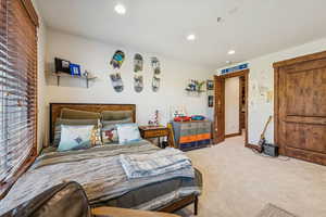 Carpeted bedroom featuring recessed lighting and baseboards
