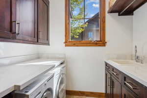 Washroom with washing machine and clothes dryer and cabinet space