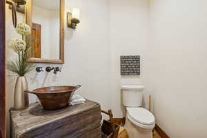 Half bathroom with toilet and a sink