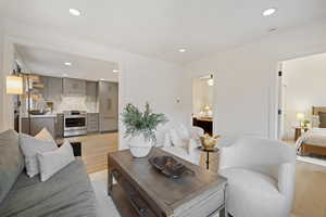 Living room featuring light wood-style flooring and recessed lighting