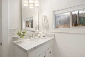 Bathroom with vanity and a chandelier