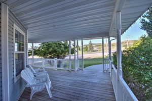 Wooden porch with a lawn