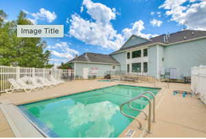 Community pool with a patio