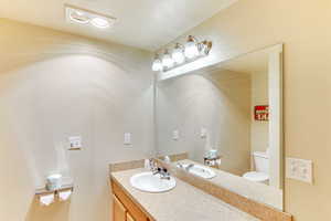 Bathroom featuring vanity and a textured ceiling