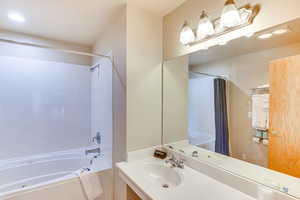Full bath featuring shower / bathtub combination with curtain, recessed lighting, and vanity
