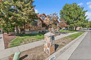 Tudor home with stone siding and a front lawn