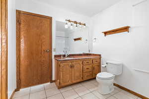 Bathroom featuring light tile patterned flooring and vanity