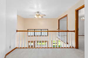 Hallway featuring carpet and a chandelier