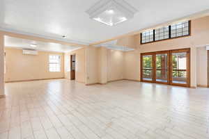 Spare room with light wood-style flooring and ornamental molding