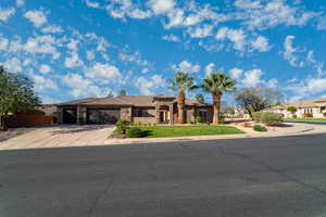 View of front of house with concrete driveway, a garage, stone siding, and stucco siding