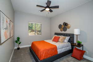 Bedroom featuring a ceiling fan and carpet flooring