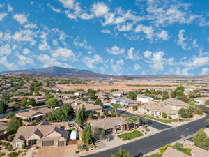 Aerial perspective of suburban area featuring a mountainous background