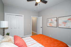 Bedroom with a closet, ceiling fan, and light wood-style floors
