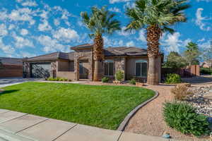View of front of home featuring stone siding, stucco siding, a garage, and driveway
