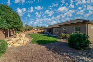 Rear view of property featuring a fenced backyard, a patio area, stucco siding, and a tile roof
