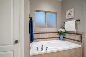 Full bath featuring a whirlpool tub