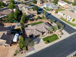 Aerial view of property and surrounding area featuring nearby suburban area