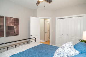 Bedroom featuring a closet, ceiling fan, and light wood finished floors