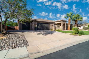 Prairie-style home featuring stone siding, an attached garage, driveway, stucco siding, and a tile roof