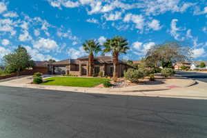 View of front of home with stone siding, stucco siding, driveway, and an attached garage