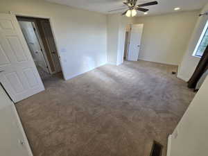 Unfurnished room featuring carpet flooring and ceiling fan