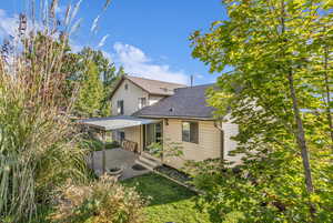 Back of property featuring a shingled roof