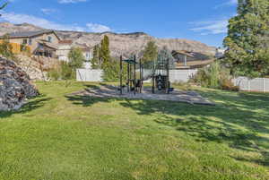 View of yard with a mountain view and a playground