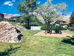 View of jungle gym featuring a mountain view