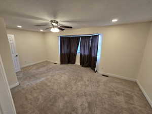 Carpeted spare room featuring recessed lighting and ceiling fan