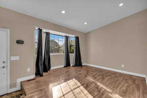 Spare room with wood finished floors and recessed lighting