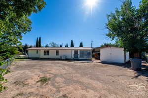 View of front of property featuring a storage shed