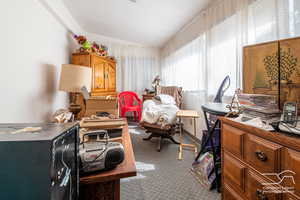 Dining area with vaulted ceiling and dark carpet