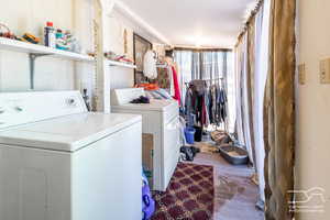 Laundry room with carpet flooring and washing machine and dryer