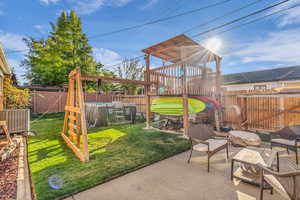 View of playground featuring a fenced backyard, a patio area, and an outdoor living space