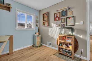 Office space featuring light wood-style floors and baseboards